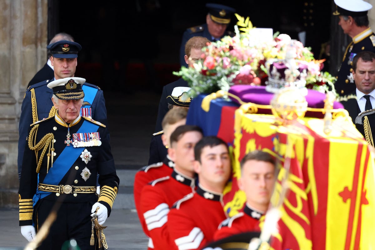 Prince William and King Charles, who exhibited a 'tiny sign' of 'self-soothing' at Queen Elizabeth's funeral according to a body language expert, walk in Queen Elizabeth's funeral