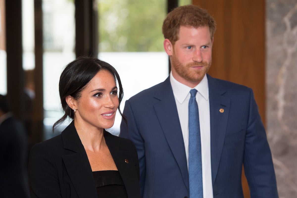 Meghan Markle, who, according to a body language expert employed a 'canny gesture' not to overshadow Prince Harry, attends the 2018 WellChild Awards with Prince Harry