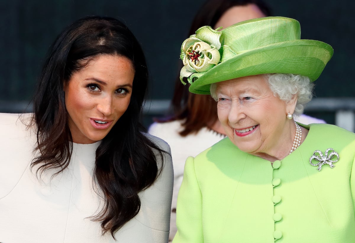 Meghan Markle, who according to Katie Nicholl’s 'The New Royals' was told off by Queen Elizabeth after getting 'upset' with a wedding caterer, sits next to Queen Elizabeth in 2018