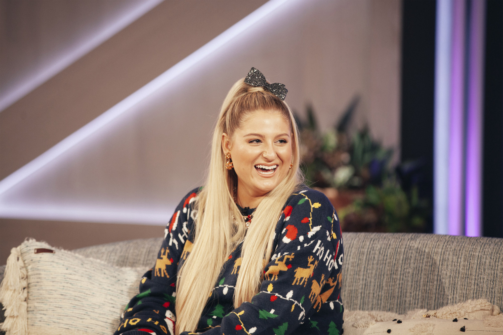 Meghan Trainor, who has written songs for Jennifer Lopez and Tim McGraw, wearing a black Christmas sweater.