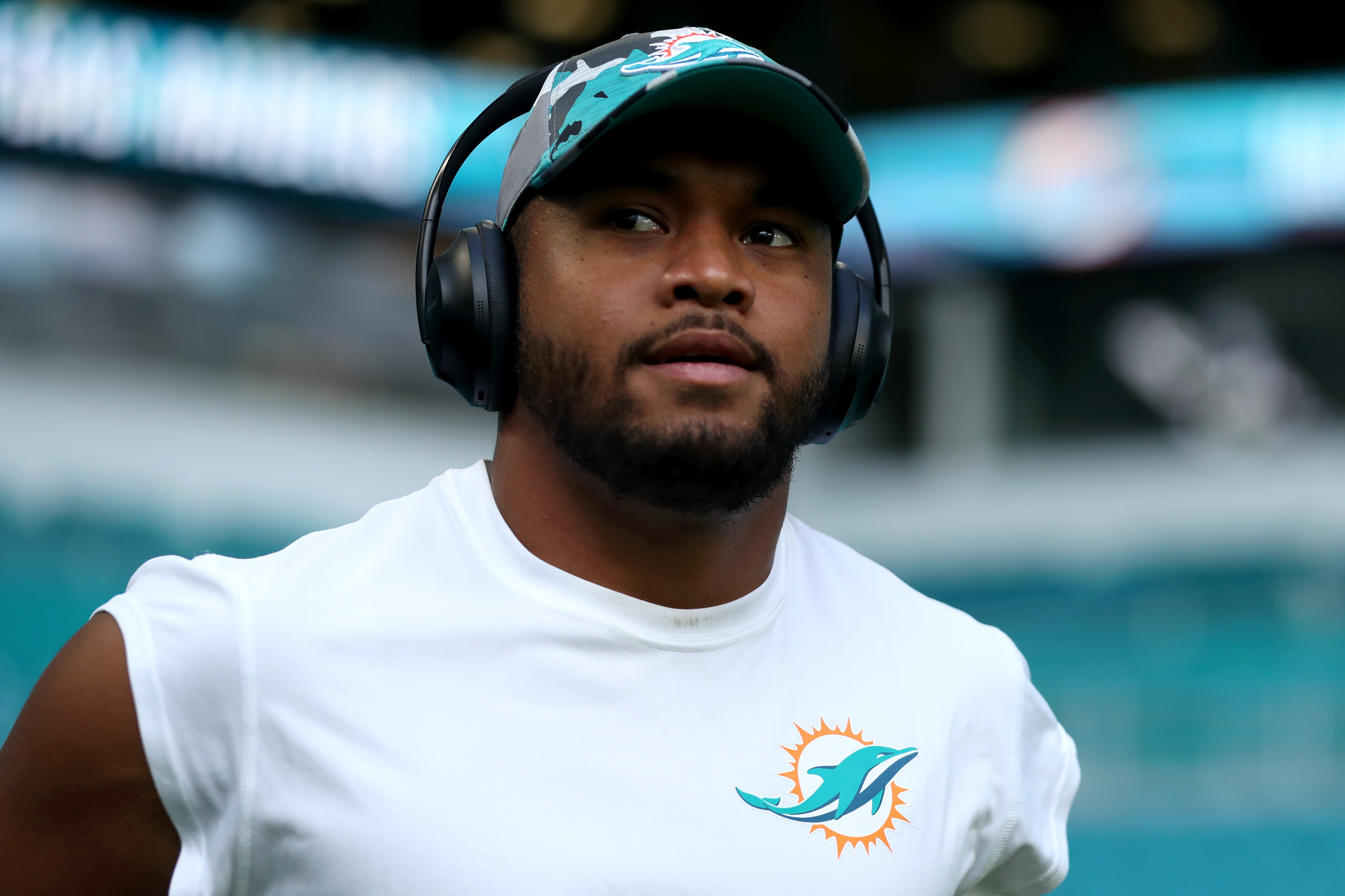 Miami Dolphins quarterback Tua Tagovailoa, who's married to Annah Gore, takes the field wearing headphones prior to a game against the Las Vegas Raiders