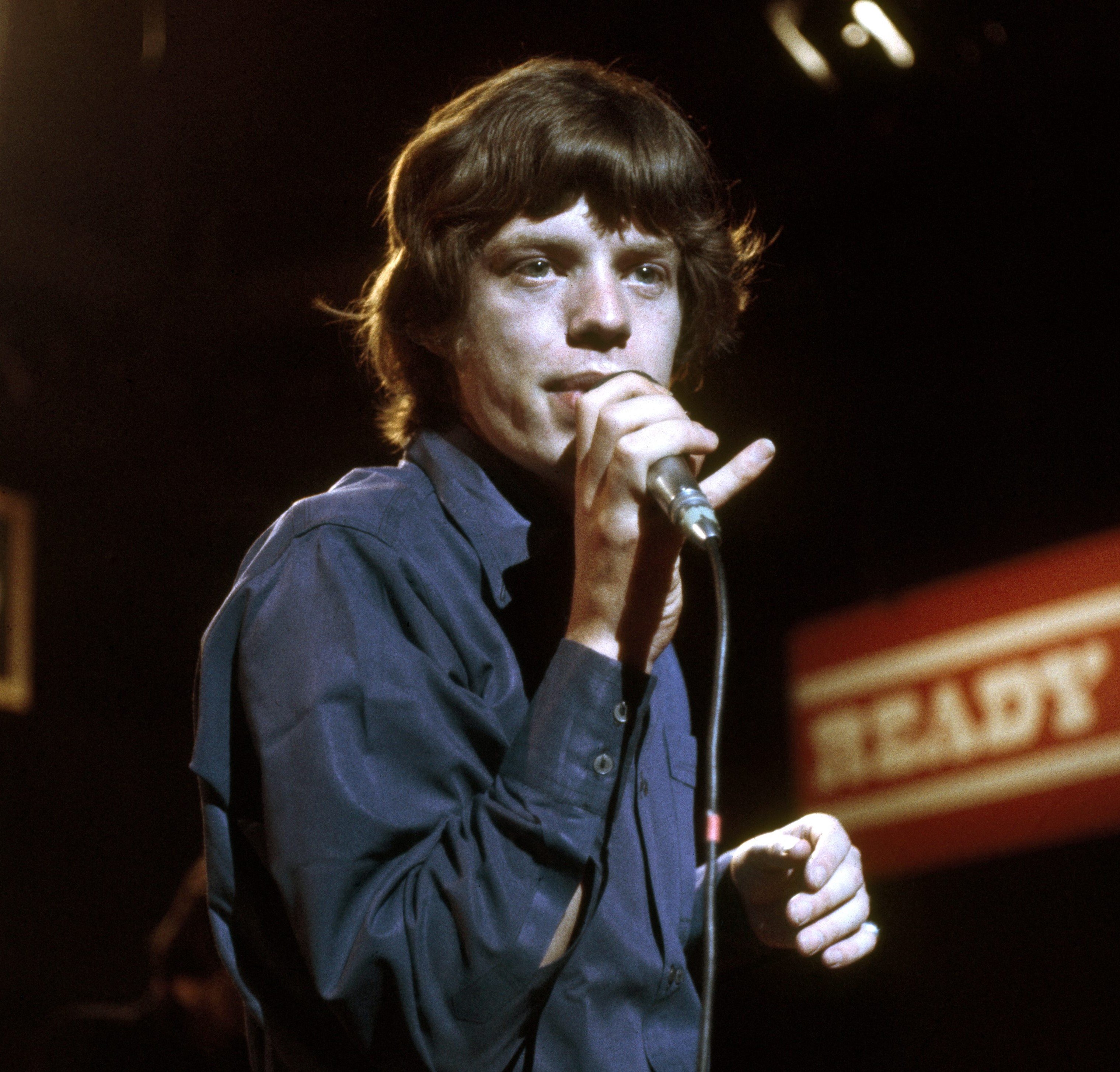 The Rolling Stones' Mick Jagger holding a microphone
