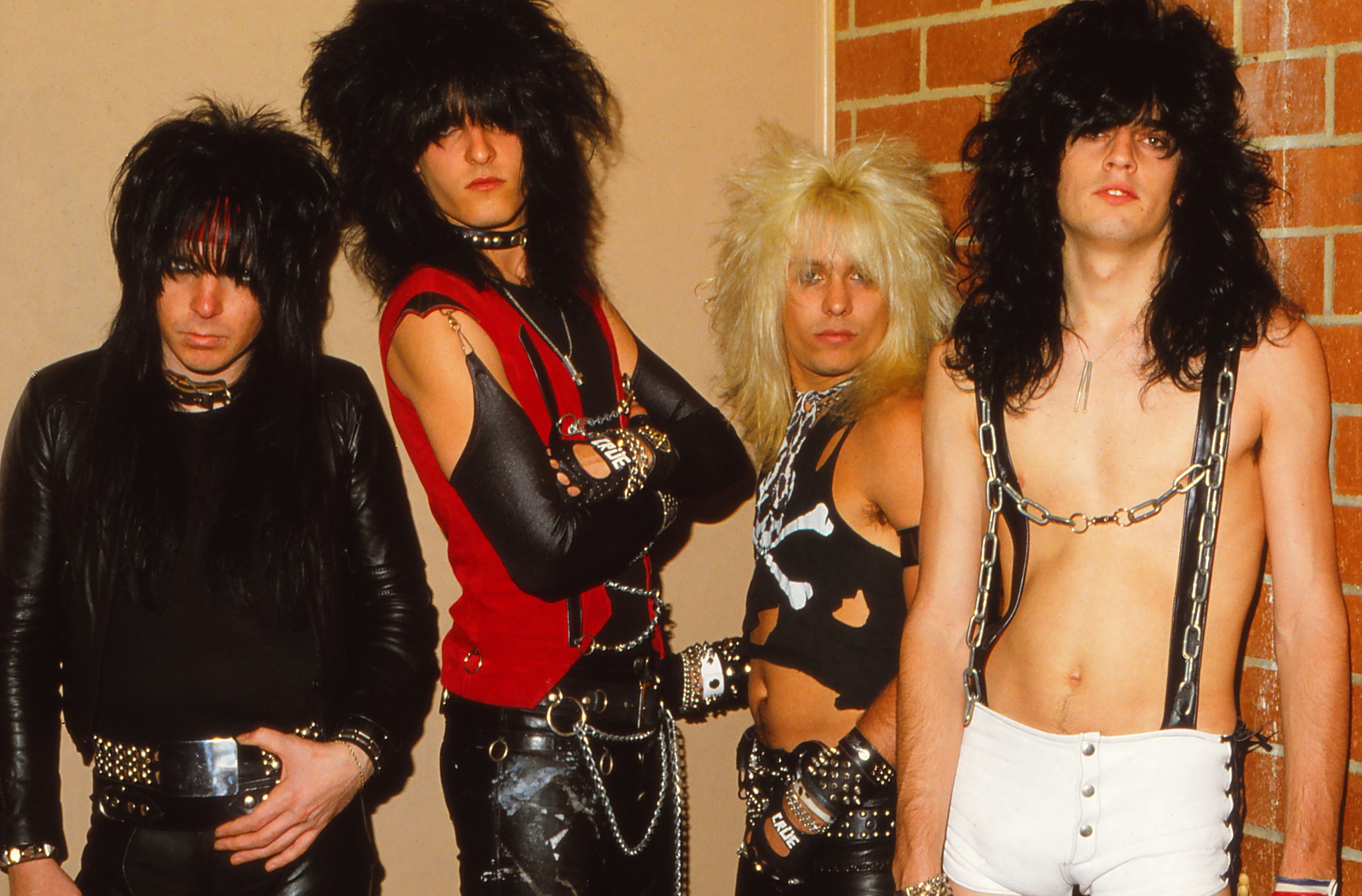 Mötley Crüe in front of a wall