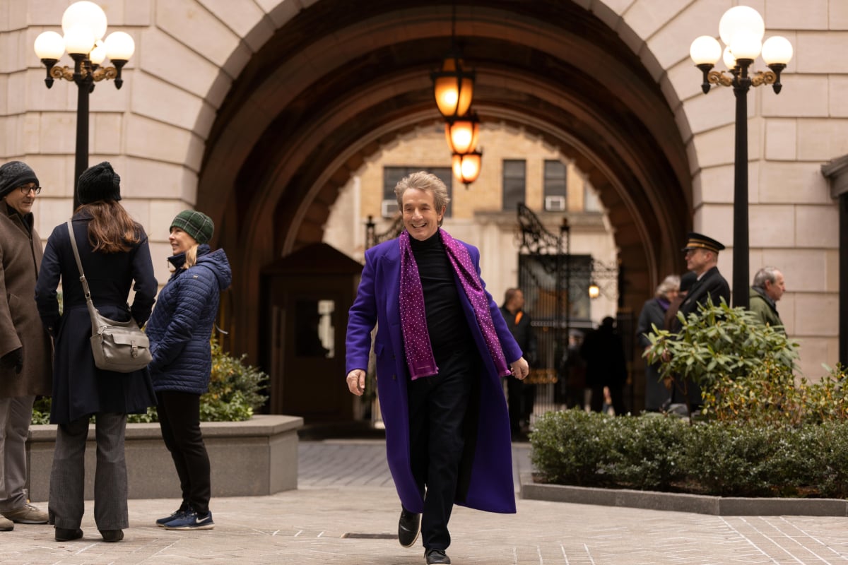 Martin Short as Oliver in Only Murders in the Building. Oliver wears a purple coat and scarf.