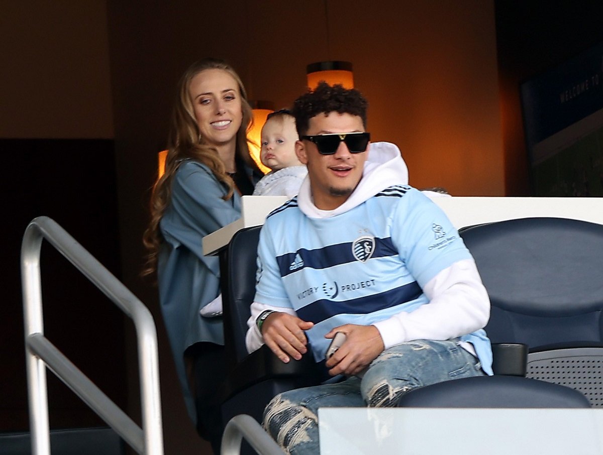 Patrick Mahomes and his wife Brittany Mahomes watching at a soccer game with their daughter Sterling