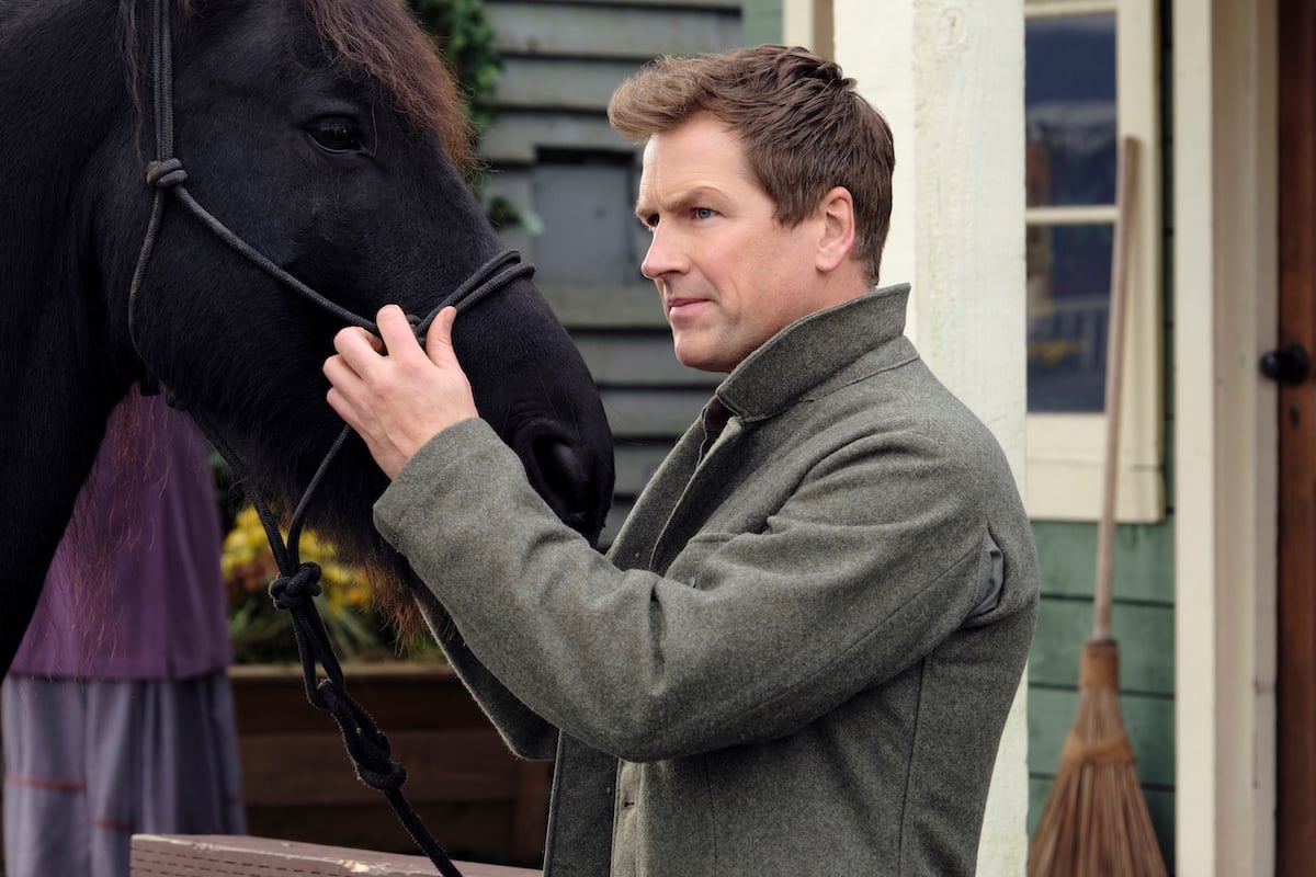 Paul Greene standing next to a horse in 'When Calls the Heart' Season 8