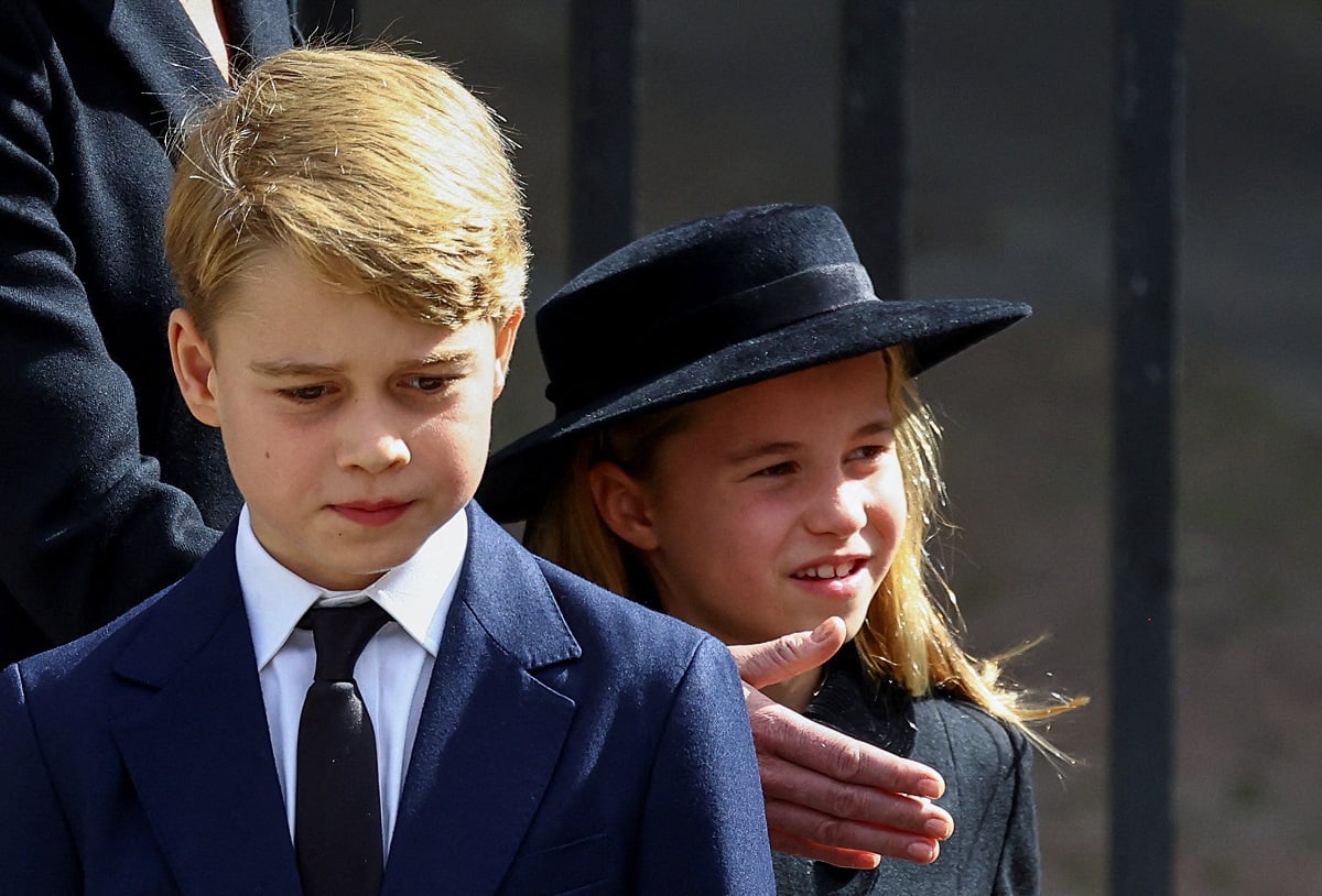 Prince George looking somber as he stands next to his sister, Princess Charlotte, following Queen Elizabeth's funeral
