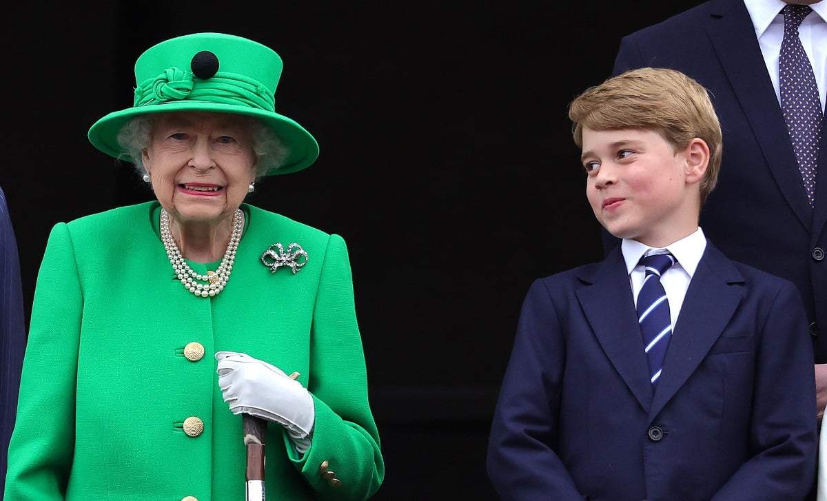 Prince George, whose body language toward his great-grandmother was analyzed, standing on the Buckingham Palace balcony and smiling at Queen Elizabeth II during the Platinum Jubilee Pageant
