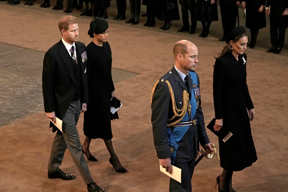 Prince Harry and Meghan Markle holding hands as Prince William and Kate Middleton do not when leaving Westminster Hall