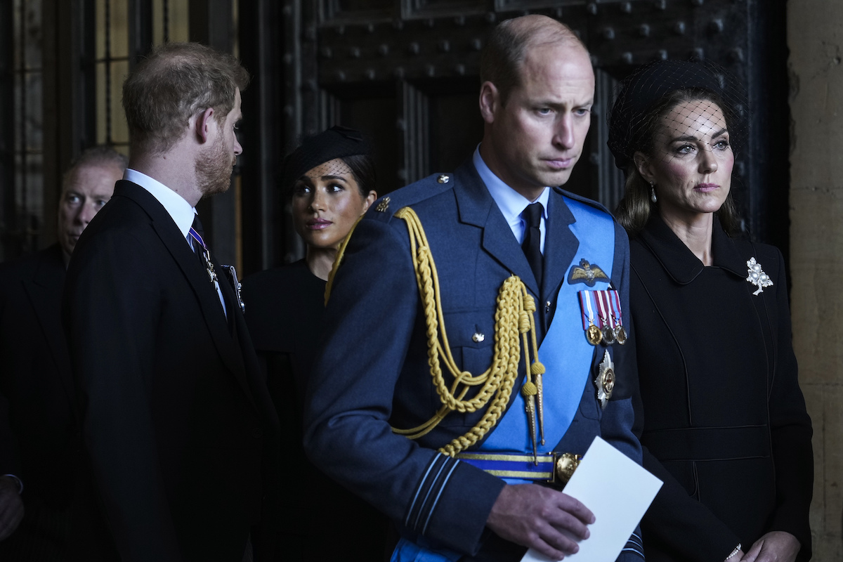 Prince Harry, Meghan Markle, Prince William, and Kate Middleton walk behind each other at a service in the days leading up to Queen Elizabeth's funeral at Westminster Abbey on Sept. 19, 2022