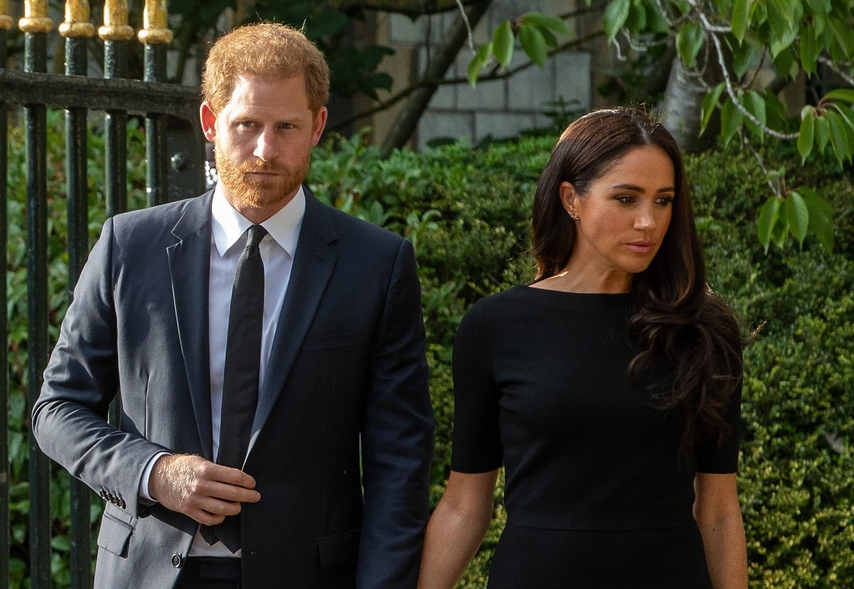 Prince Harry and Meghan Markle arrive to view floral tributes to Queen Elizabeth II laid outside at Windsor Castle