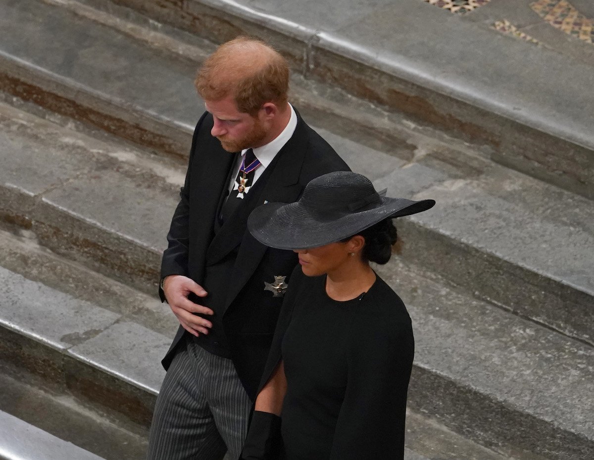 Prince Harry, who shouldn't publish his memoir according to author Tina Brown and instead 'compromise' with the royal family, walks with Meghan Markle at Queen Elizabeth's funeral
