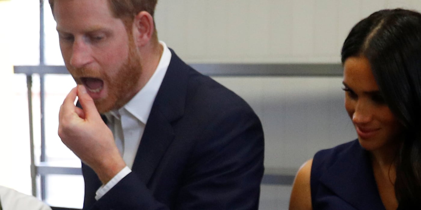 Prince Harry and Meghan Markle eating during a photo op.