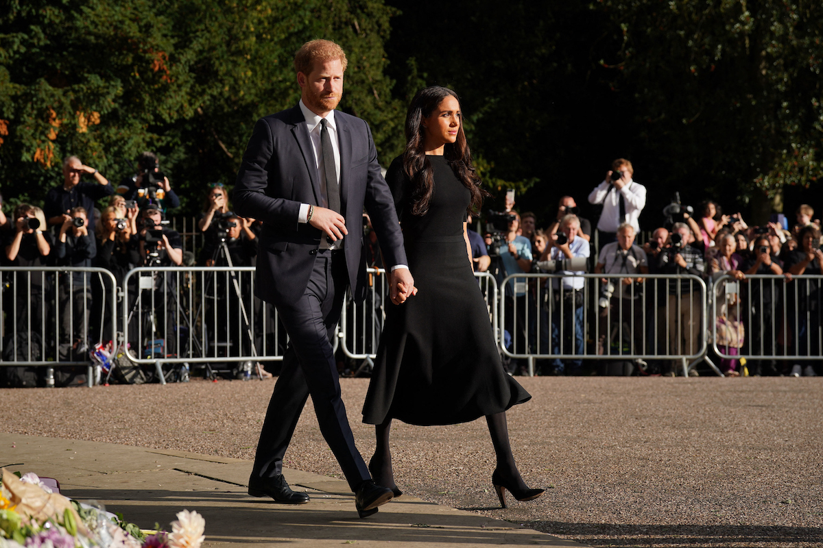Prince Harry and Meghan Markle, who reportedly 'never reached out' to Prince William and Kate Middleton before returning to the U.K. in September 2022, greet well-wishers during a walkabout outside Windsor Castle following Queen Elizabeth's death