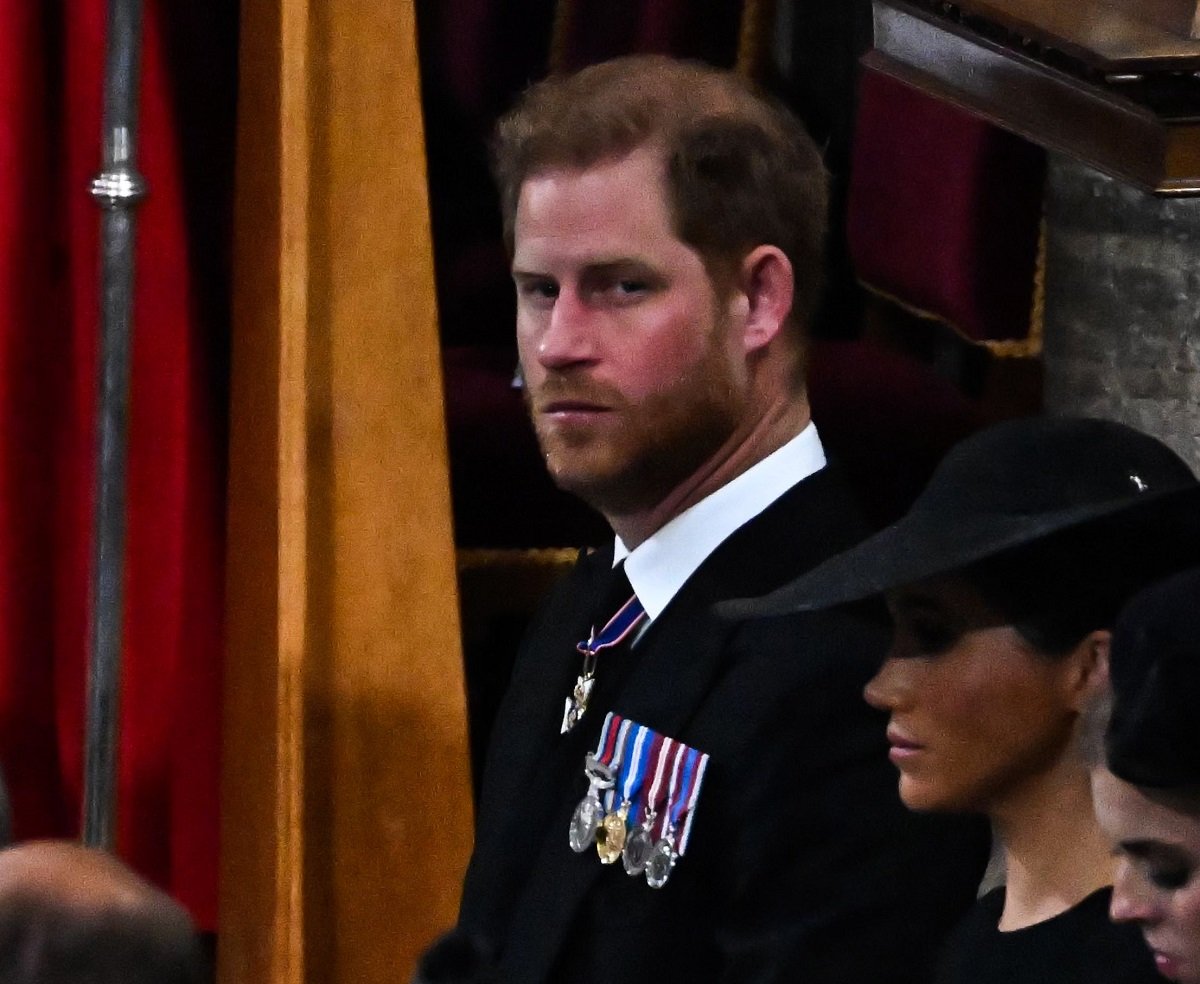 Prince Harry and Meghan Markle sitting in the second row at Queen Elizabeth II's funeral