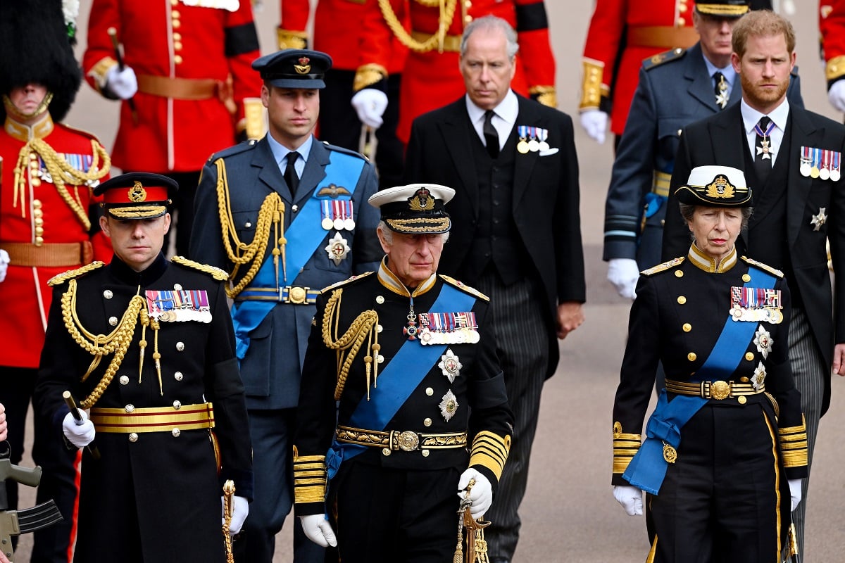 Prince Harry walking with members of his family in procession behind Queen Elizabeth's hearse ahead of the Committal Service
