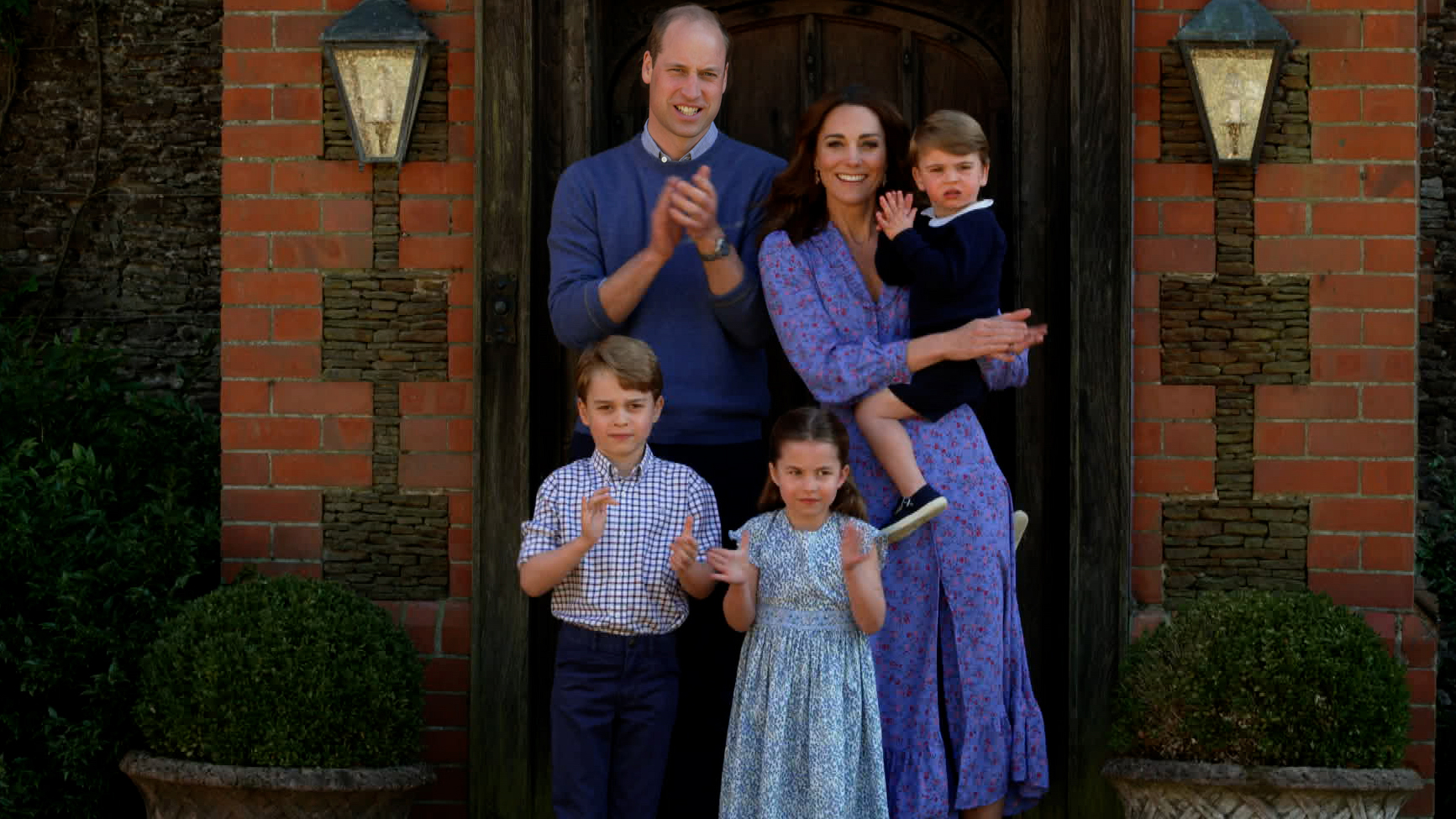 Prince William and Kate Middleton pose for a family photo with their children.