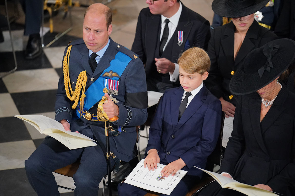 Prince William, who along with King Charles exhibited a "tiny sign" of "self-soothing" at Queen Elizabeth's funeral, sits with Prince George and Kate Middleton at Westminster Abbey on Sept. 19, 2022