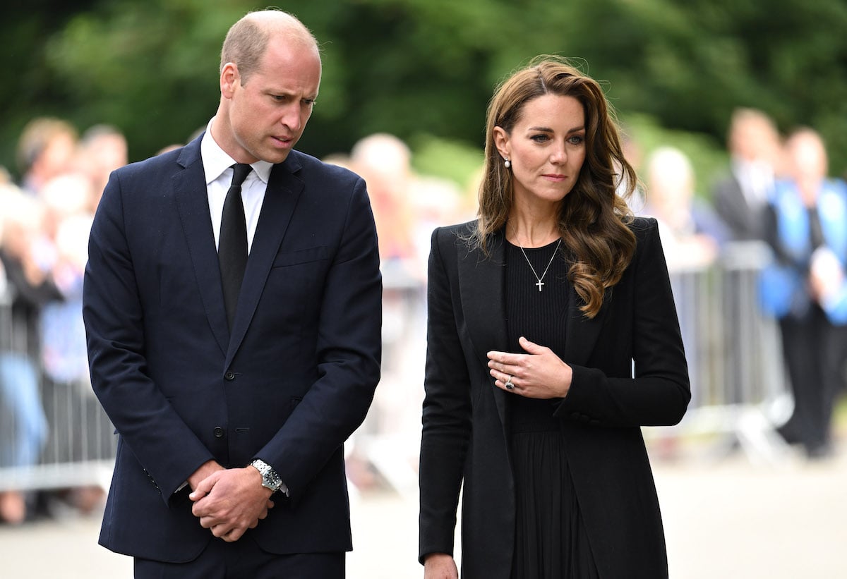 Prince William and Kate Middleton, whose movements a body language expert broke down following a visit to Sandringham on September 15, 2022, look at tributes to the queen