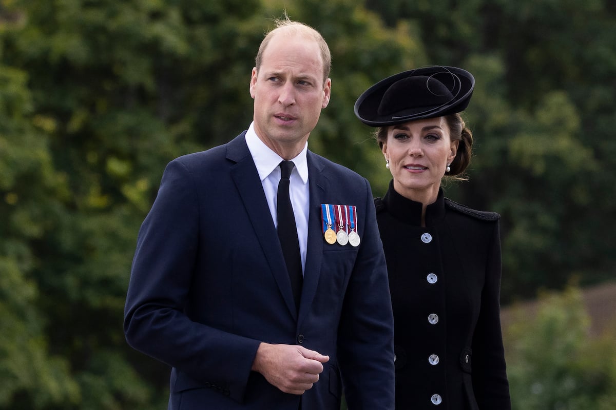 Prince William and Kate Middleton, who a body language said appeared 'unusually tactile' while visiting troops on Sept. 16, 2022, walk together while visiting troops who will participate in Queen Elizabeth's funeral