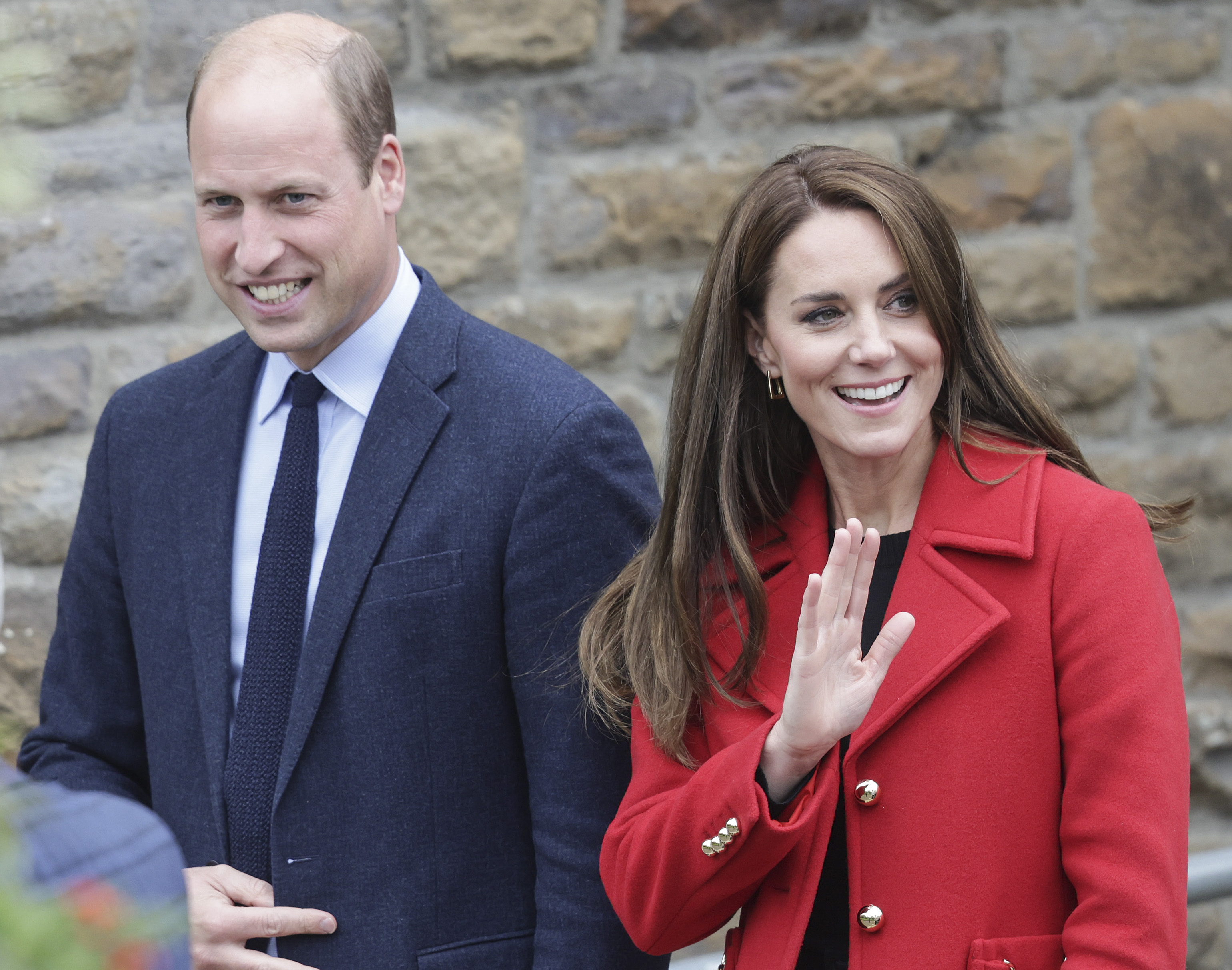 Prince William and Kate Middleton smile and wave to crowd as they leave church in Swansea, Wales