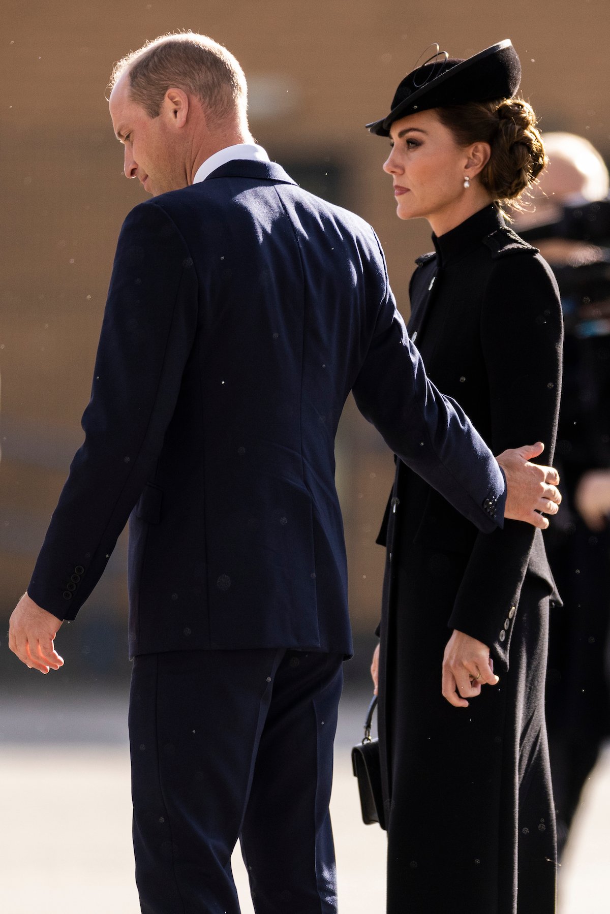 Prince William touches Kate Middleton during a Sept. 16 visit to see troops ahead of Queen Elizabeth's funeral during which a body language expert described Prince William and Kate Middleton as 'unusually tactile.'