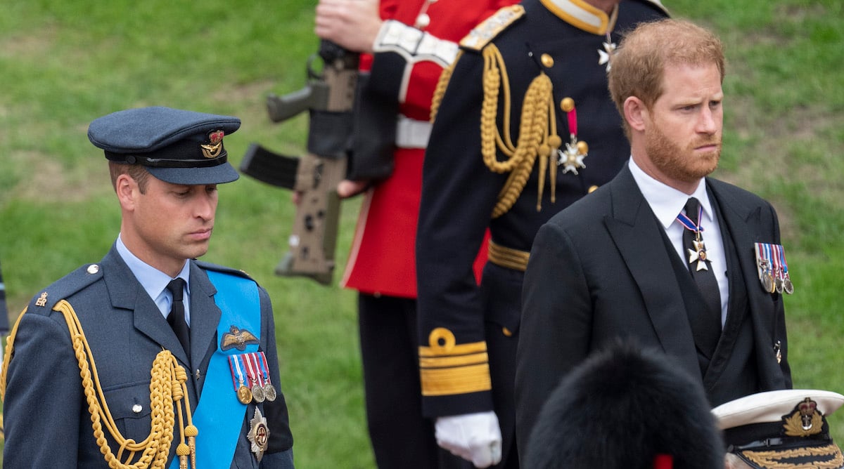 Prince William, who had a five-word reply to Prince Harry's question at St. George's Chapel according to a lip reader, stand outside during Queen Elizabeth's funeral