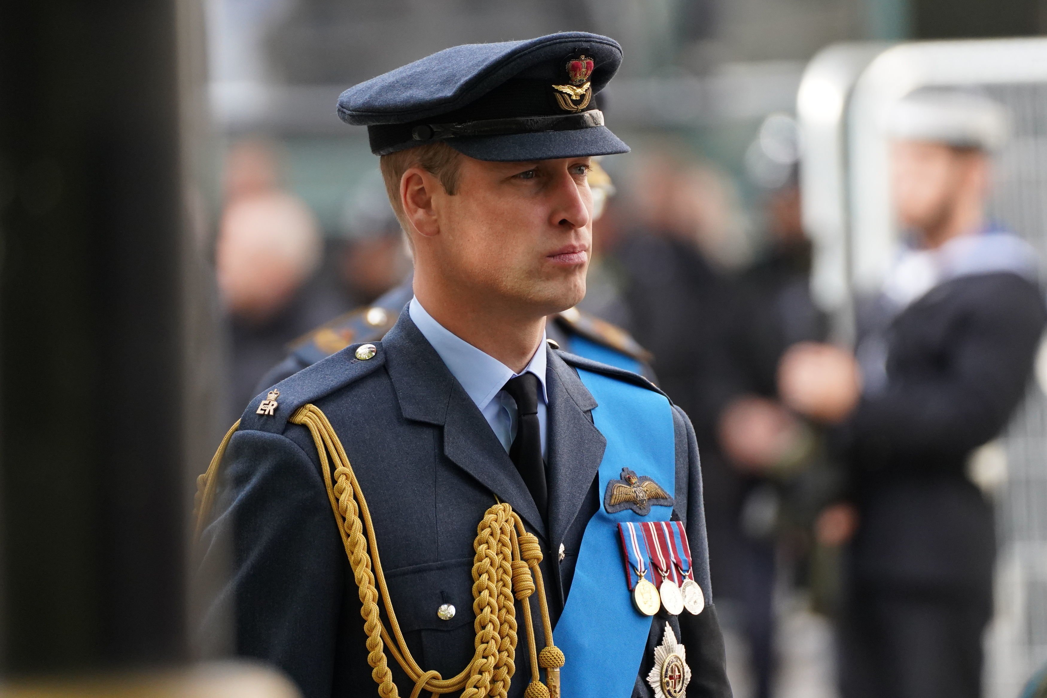 Prince William, who may skip his Prince of Wales ceremony, following the coffin of Queen Elizabeth II as it leaves Westminster Abbey