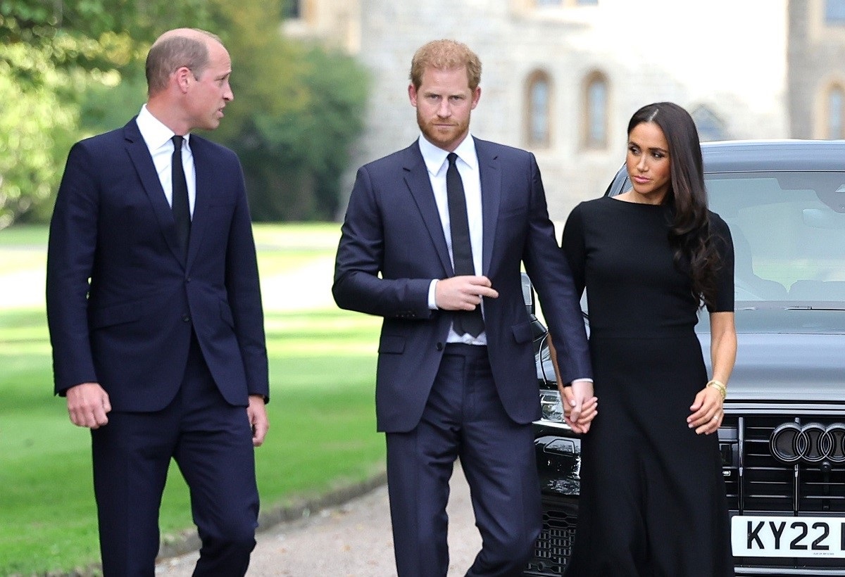 Prince William, who reportedly stuck up or a staffer allegedly mistreated by Meghan, walking next to Prince Harry and Meghan Markle as they arrive at Windsor Castle to view flowers and tributes to Queen Elizabeth II