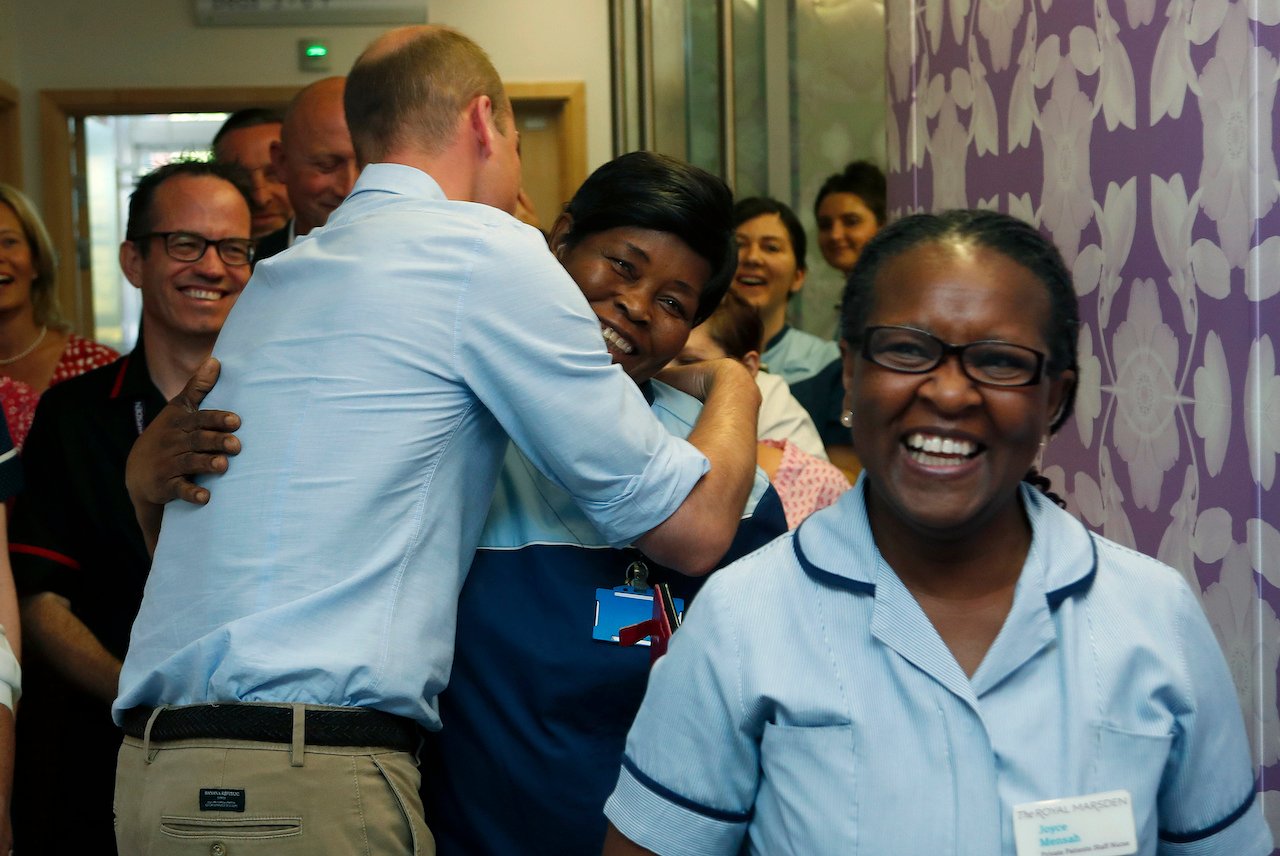 Prince William hugs a cleaner as he visits The Royal Marsden in 2019