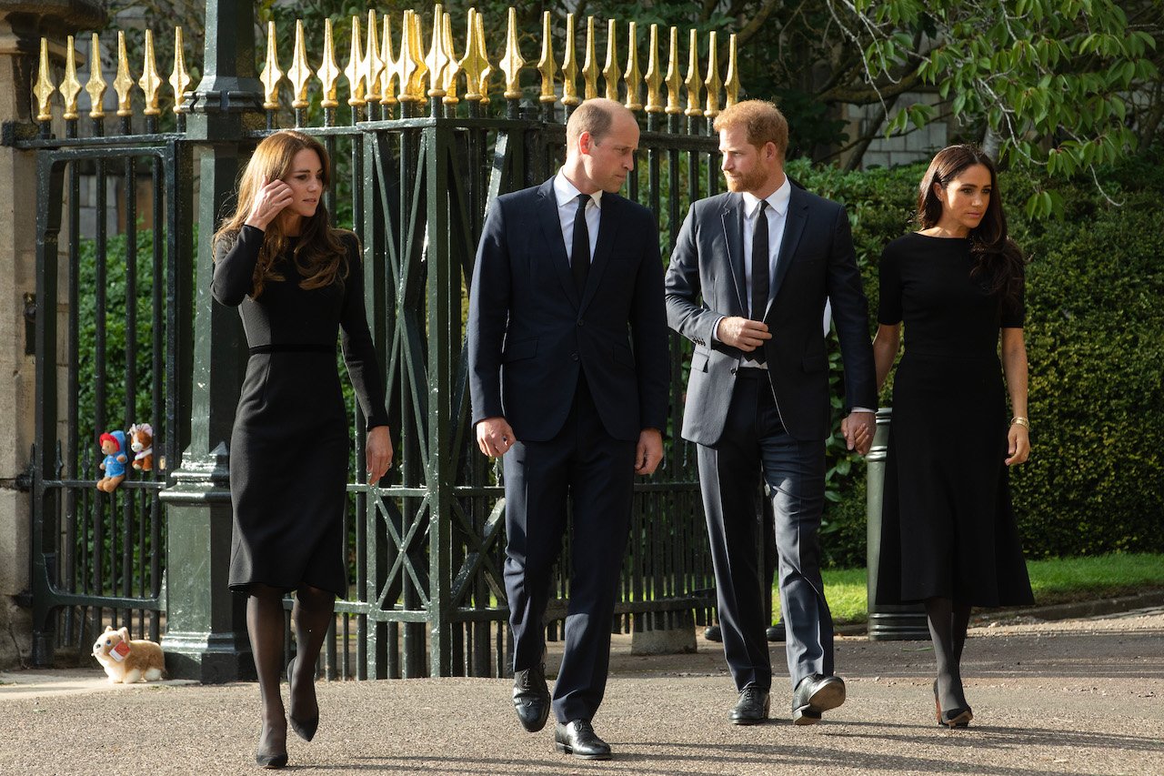 (L-R) Kate Middleton, Prince William, Prince Harry, and Meghan Markle arrive to view floral tributes to Queen Elizabeth II. A body language expert said William and Kate were 'in sync' despite distance.