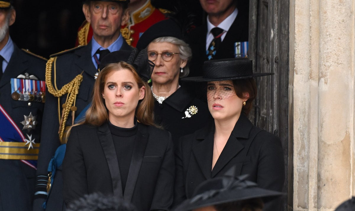 Princesses Beatrice and Eugenie stand outside Westminster Abbey during a state service in a photo from Queen Elizabeth's funeral