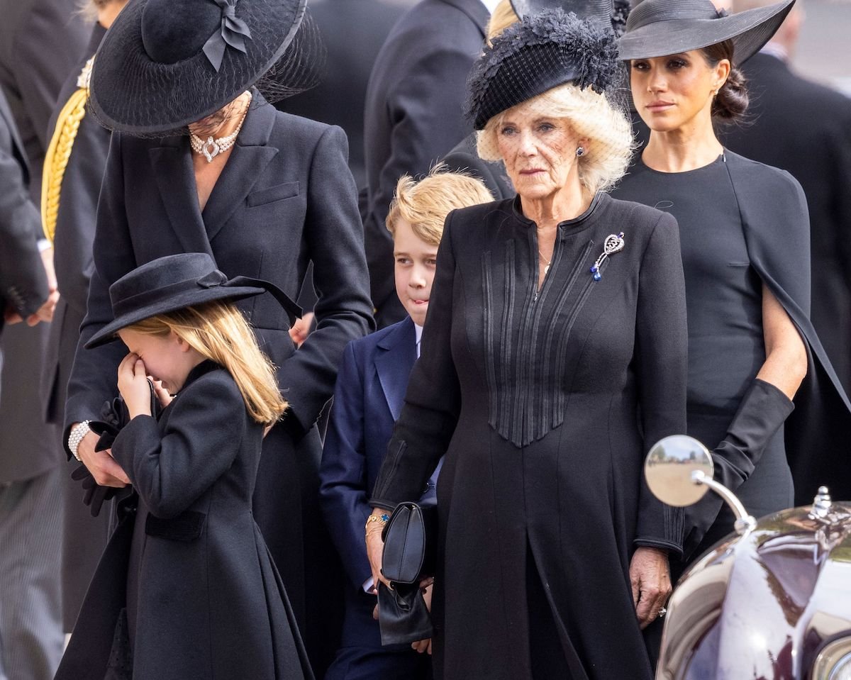 Princess Charlotte cries outside of Westminster Abbey after Queen Elizabeth's funeral standing next to Kate Middleton, Prince George, the Queen Consort, and Meghan Markle