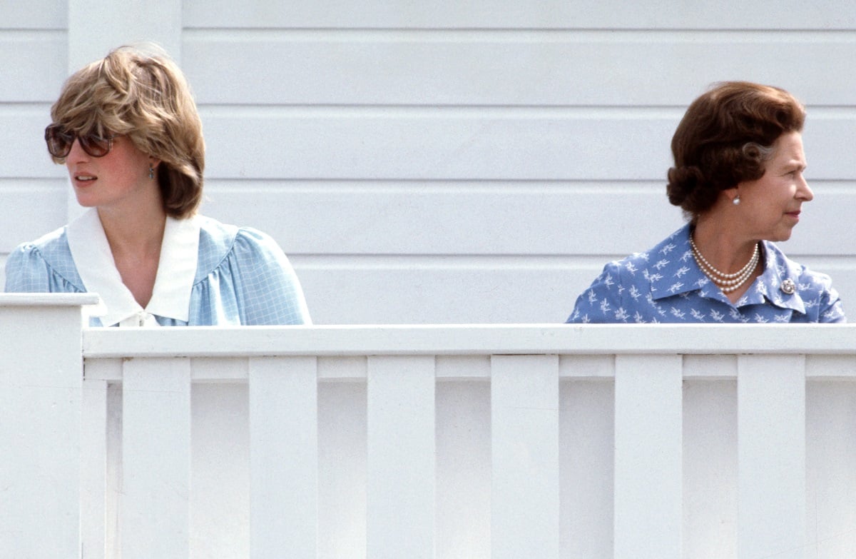 Princess Diana and Queen Elizabeth II, who had a complex relationship, sitting across from one another but looking in different directions as they attend a polo match at Guards Polo Club