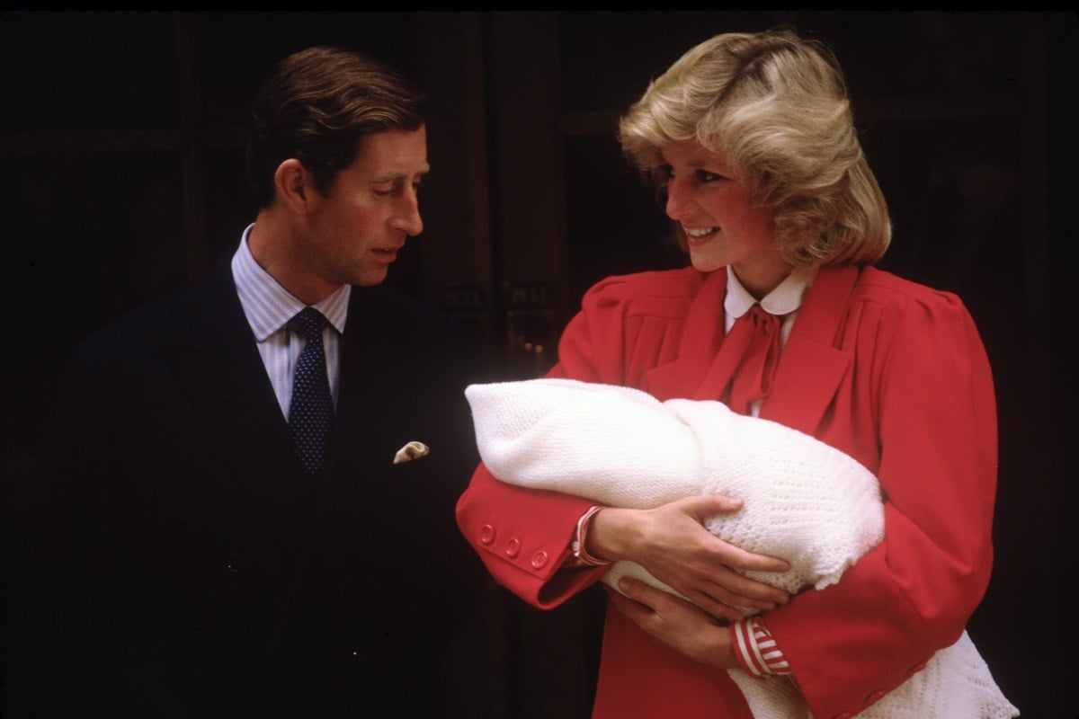 Princess Diana and then-Prince Charles, who made a comment after Prince Harry's birth that Diana's mother snapped at him for, leave St. Mary's Hospital with their youngest son