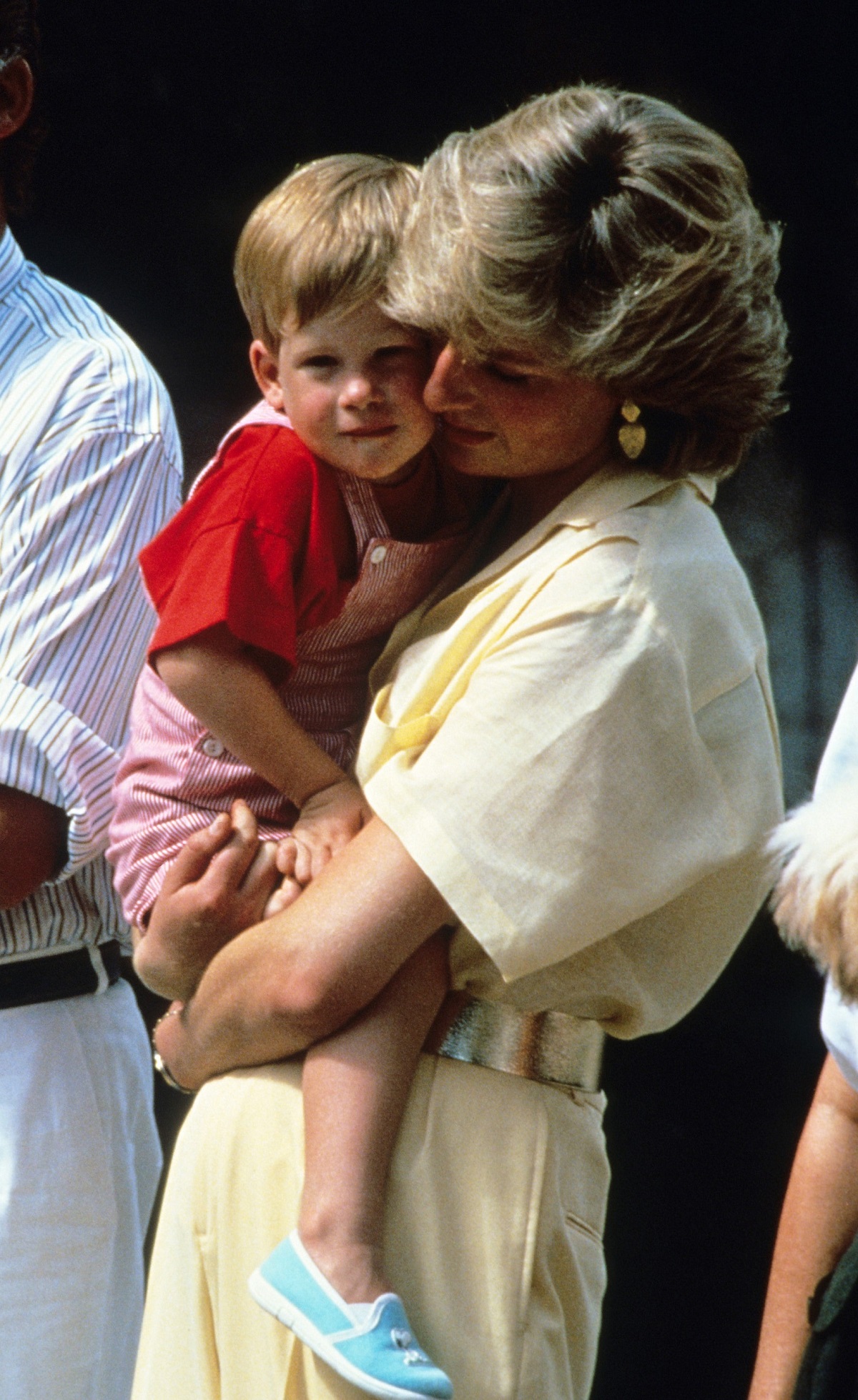 Princess Diana holding a young Prince Harry in her arms