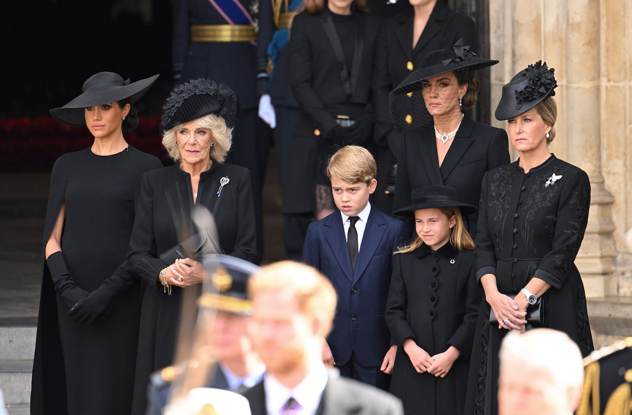 (L-R) Meghan Markle, Queen Consort Camilla, Prince George, Kate Middleton, Princess Charlotte, and Sophie Wessex at the funeral for Queen Elizabeth II. Princess Charlotte adorned a special gift from her late great-grandmother.