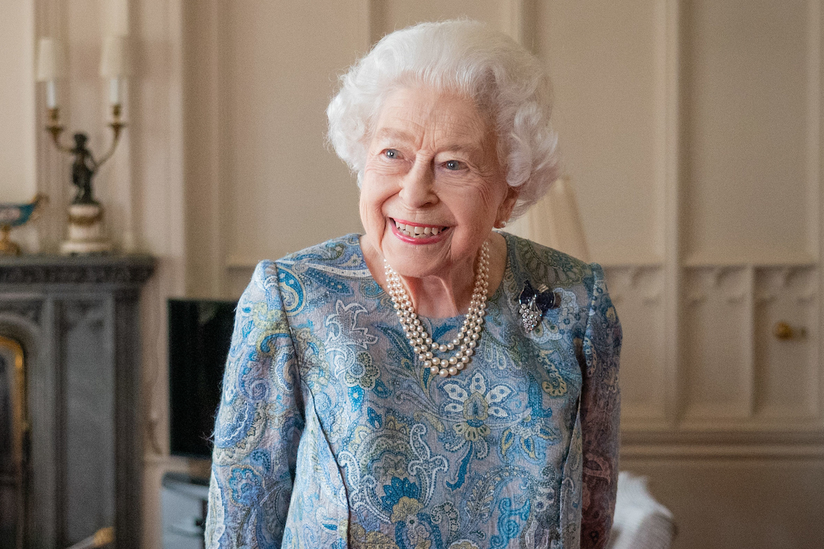 Queen Elizabeth, whose cause of death may never be revealed, smiles and looks on in April 2022