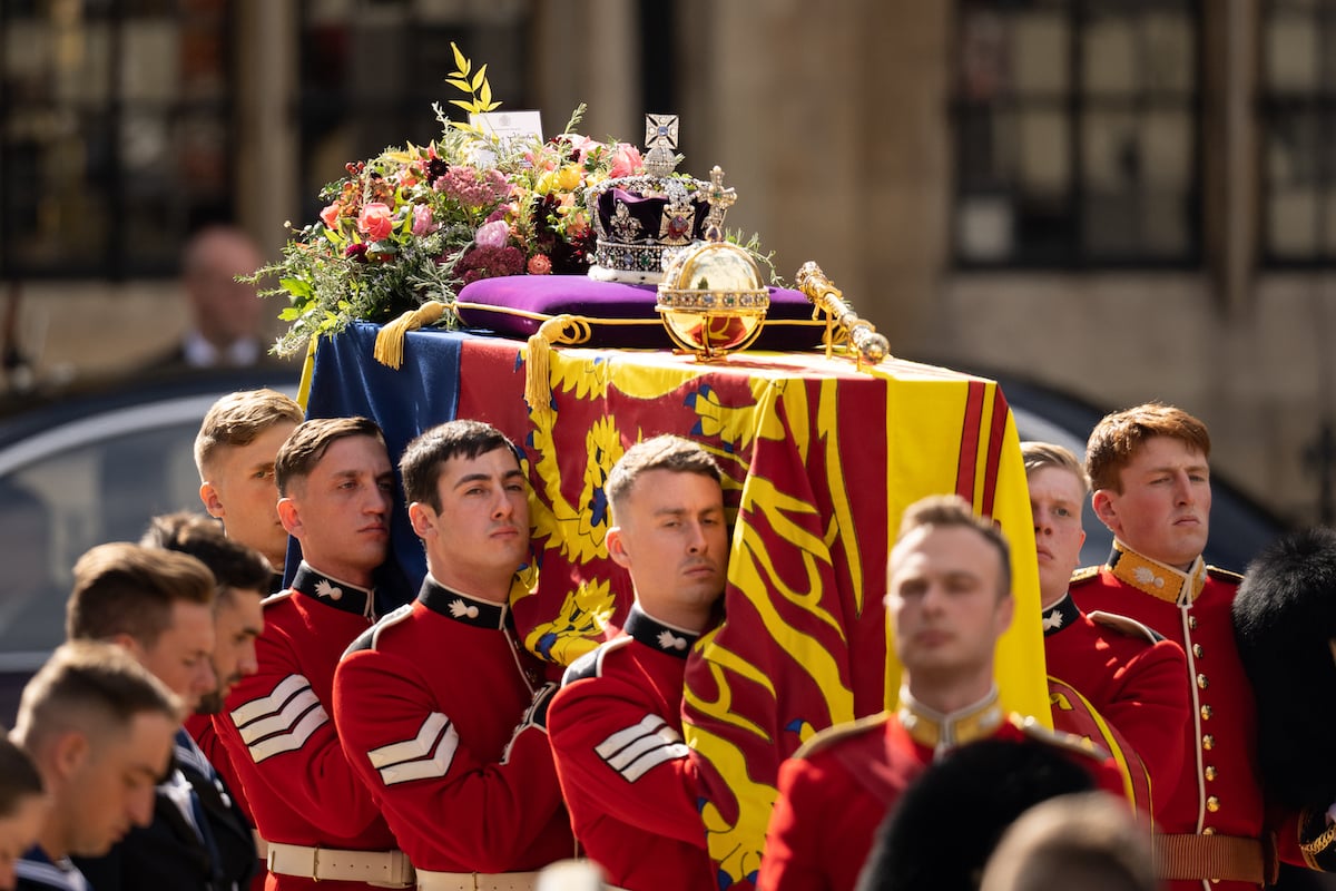 Queen Elizabeth's Imperial State Crown sits atop her coffin alongside the orb and scepter, as her coffin is taken out of Westminster Abbey during a state service on Sept. 19, 2022