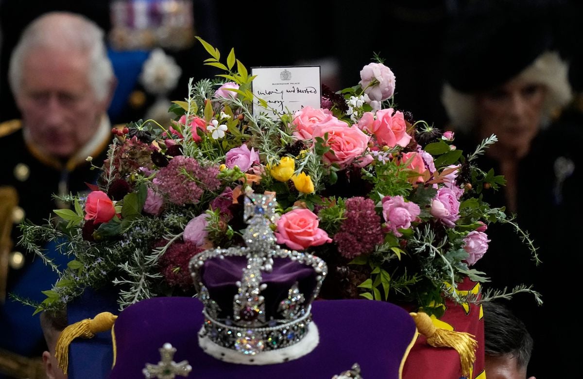 Queen Elizabeth's coffin, with a note from King Charles III on top, is carried out of Westminster Abbey following a state funeral service