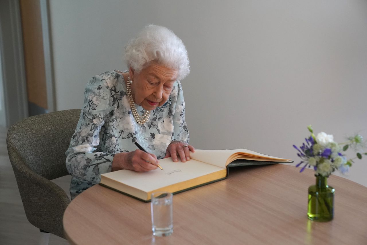 Queen Elizabeth II, pictured signing a guestbook in 2022, had a pen pal for 70 years