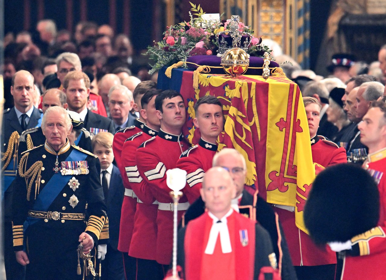 (L-R) Prince William, Prince of Wales, King Charles III, Prince Harry, Duke of Sussex and Catherine, Princess of Wales watch as HM Queen Elizabeth's coffin is carried out of the doors of Westminster Abbey during The State Funeral Of Queen Elizabeth II at Westminster Abbey on September 19, 2022 in London, England.