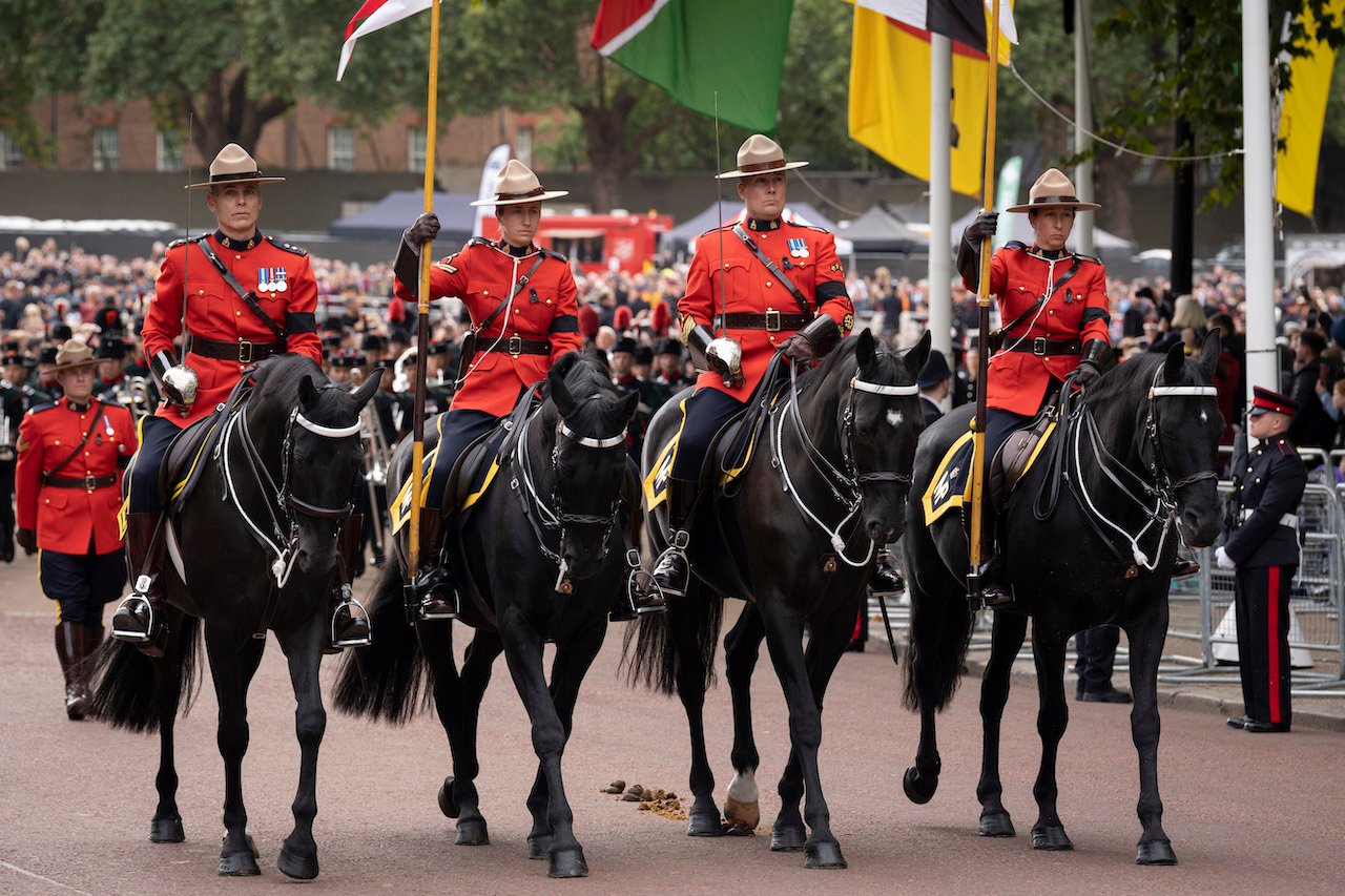 Members of the Royal Canadian Mounted Police (aka the Mounties) ride along Horseguards during her funeral procession from Westminster Abbey to Wellington Arch at Hyde Park and beyond to St George’s Chapel in Windsor Castle where she is to be interred, on 19th September 2022