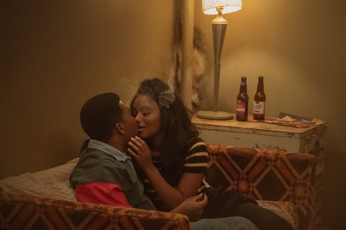 Mekai Curtis as Kanan kissing a girl on the couch in 'Power Book III: Raising Kanan'