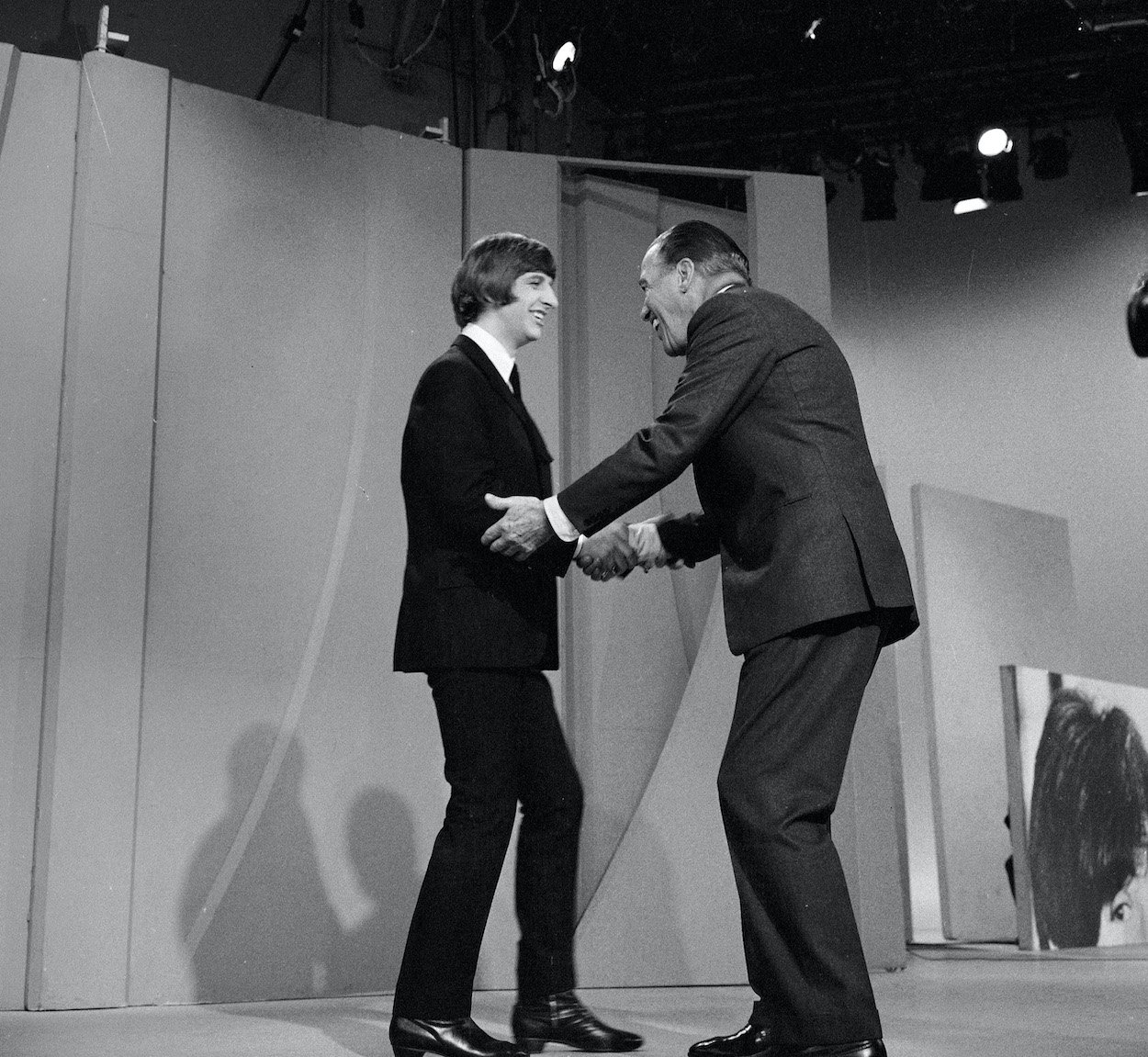 Ringo Starr (left) shakes hands with Ed Sullivan in 1965. Ringo said a chance encounter with Sullivan led to them being booked for his show, which led to international superstardom.