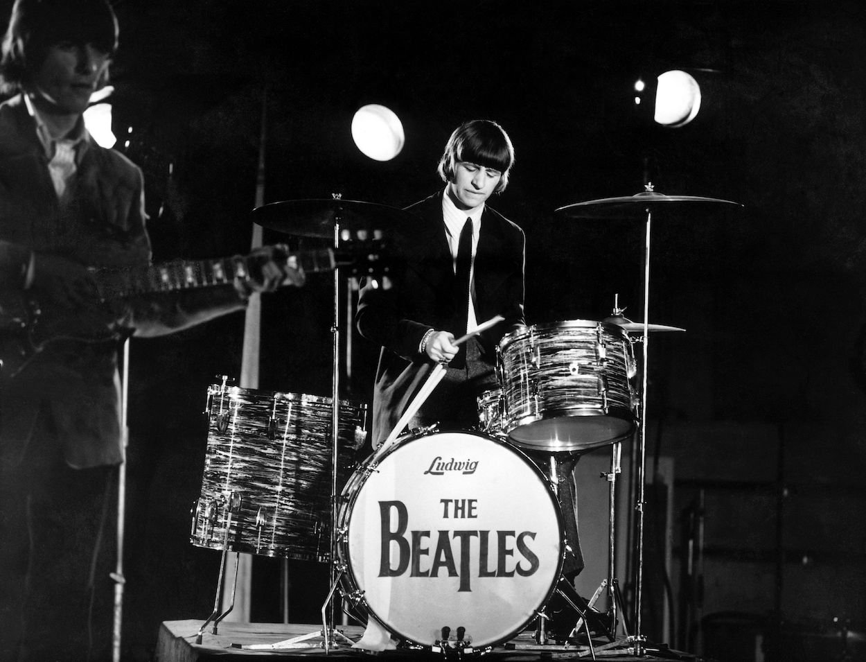 Beatles drummer Ringo Starr plays drums while filming videos for "Paperback Writer" and "Rain," which he once called one of the Beatles weird tracks.