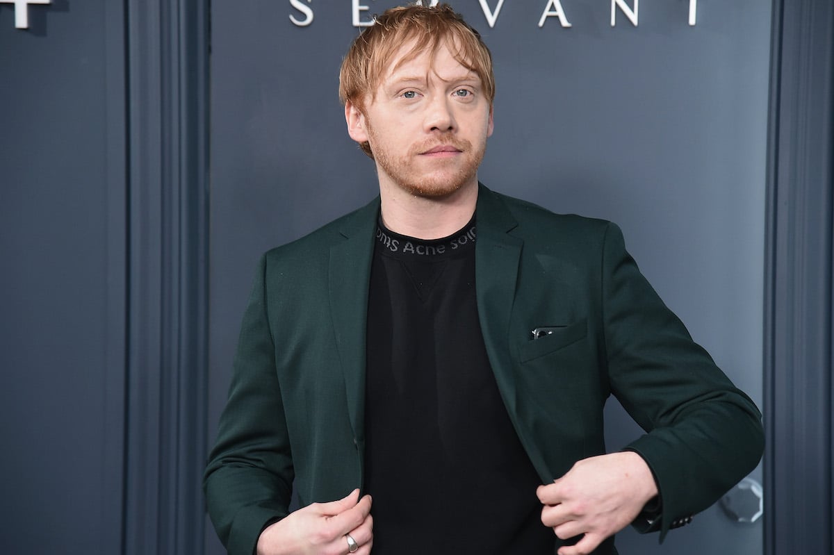 Rupert Grint in a green suit and black shirt