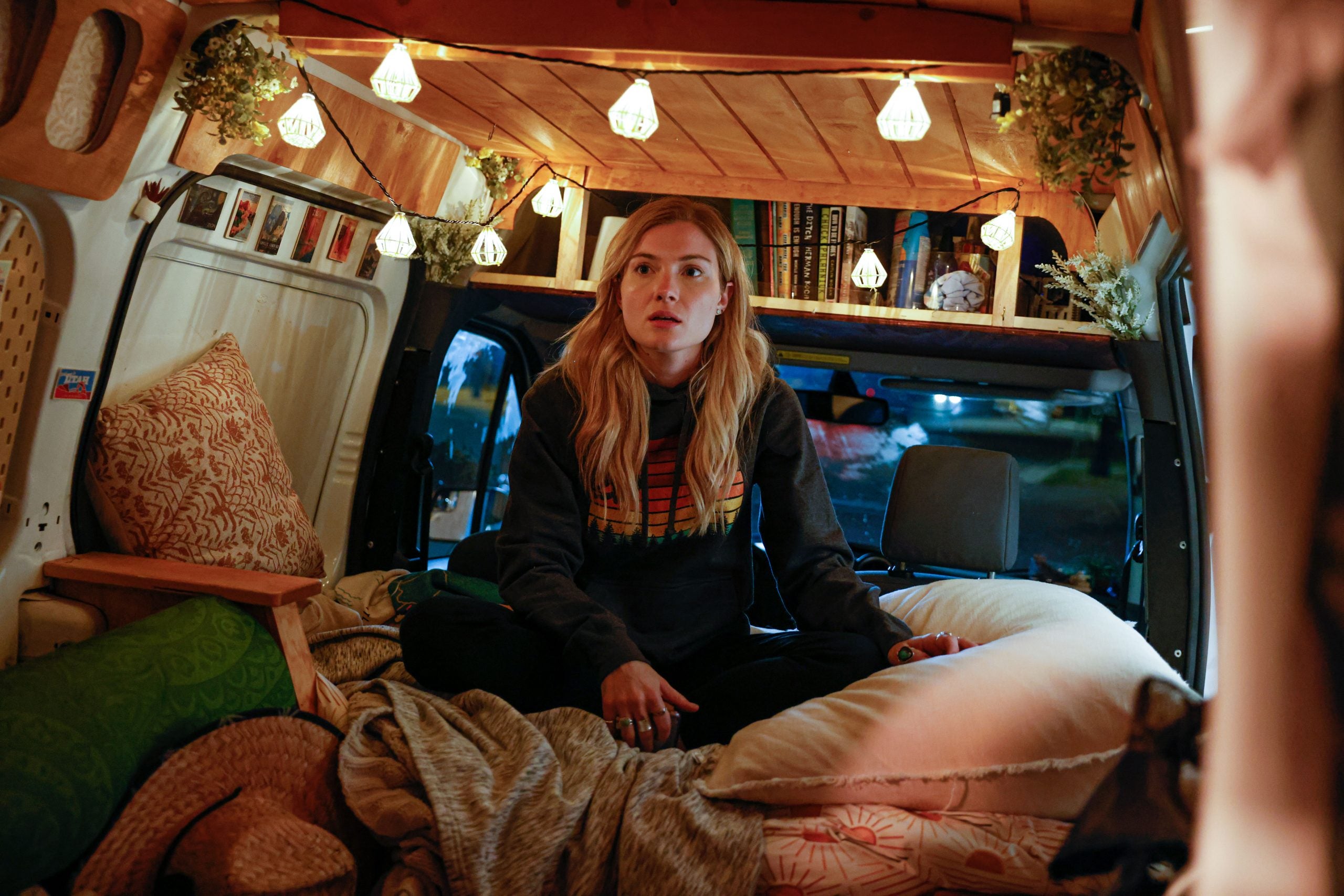 Skyler Samuels as Gabby Petito, sitting in her van, in 'The Gabby Petito Story' on Lifetime
