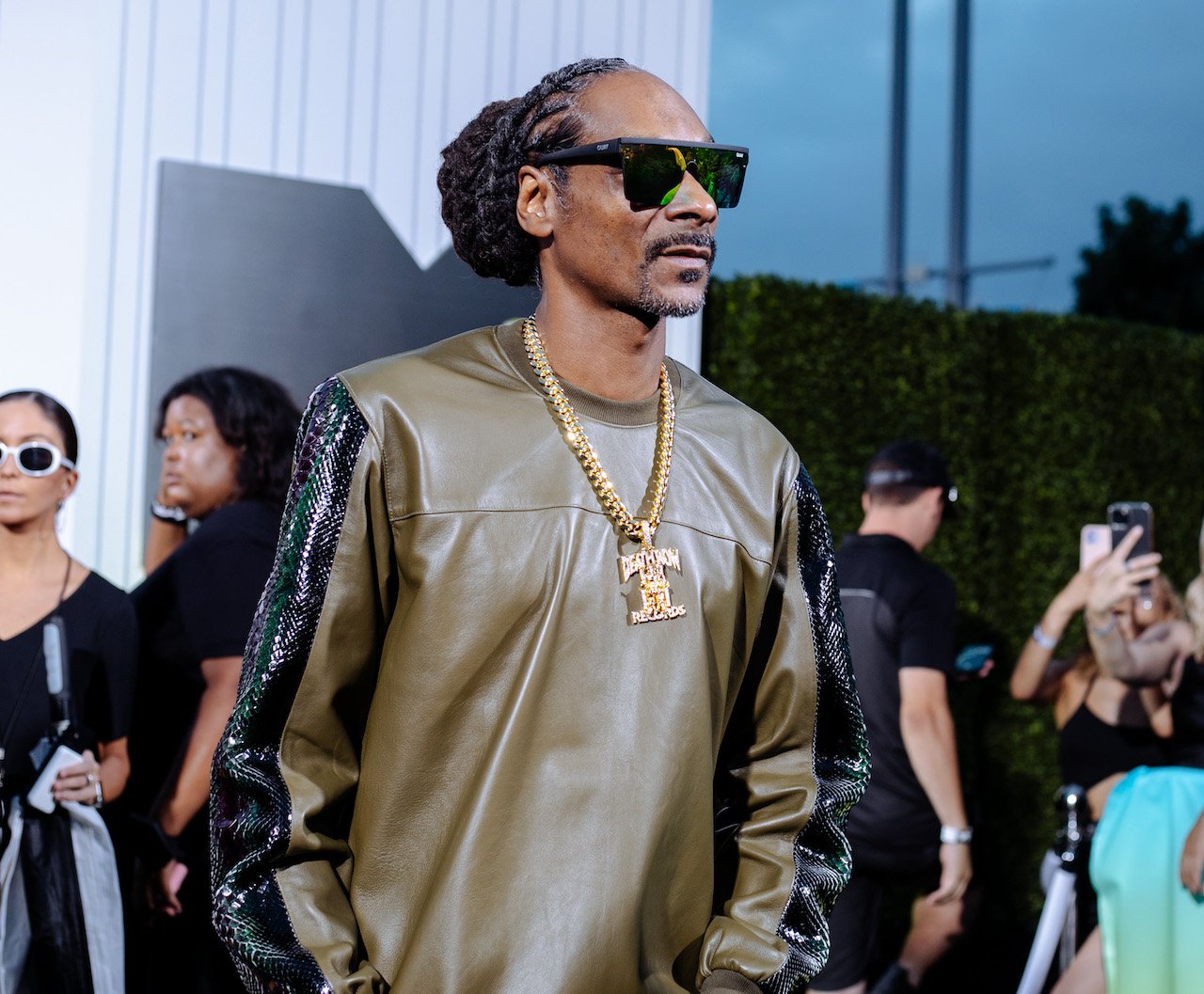 Snoop Dogg poses at the 2022 VMAs;  Snoop headlines a music festival gig with fellow West Coast artists