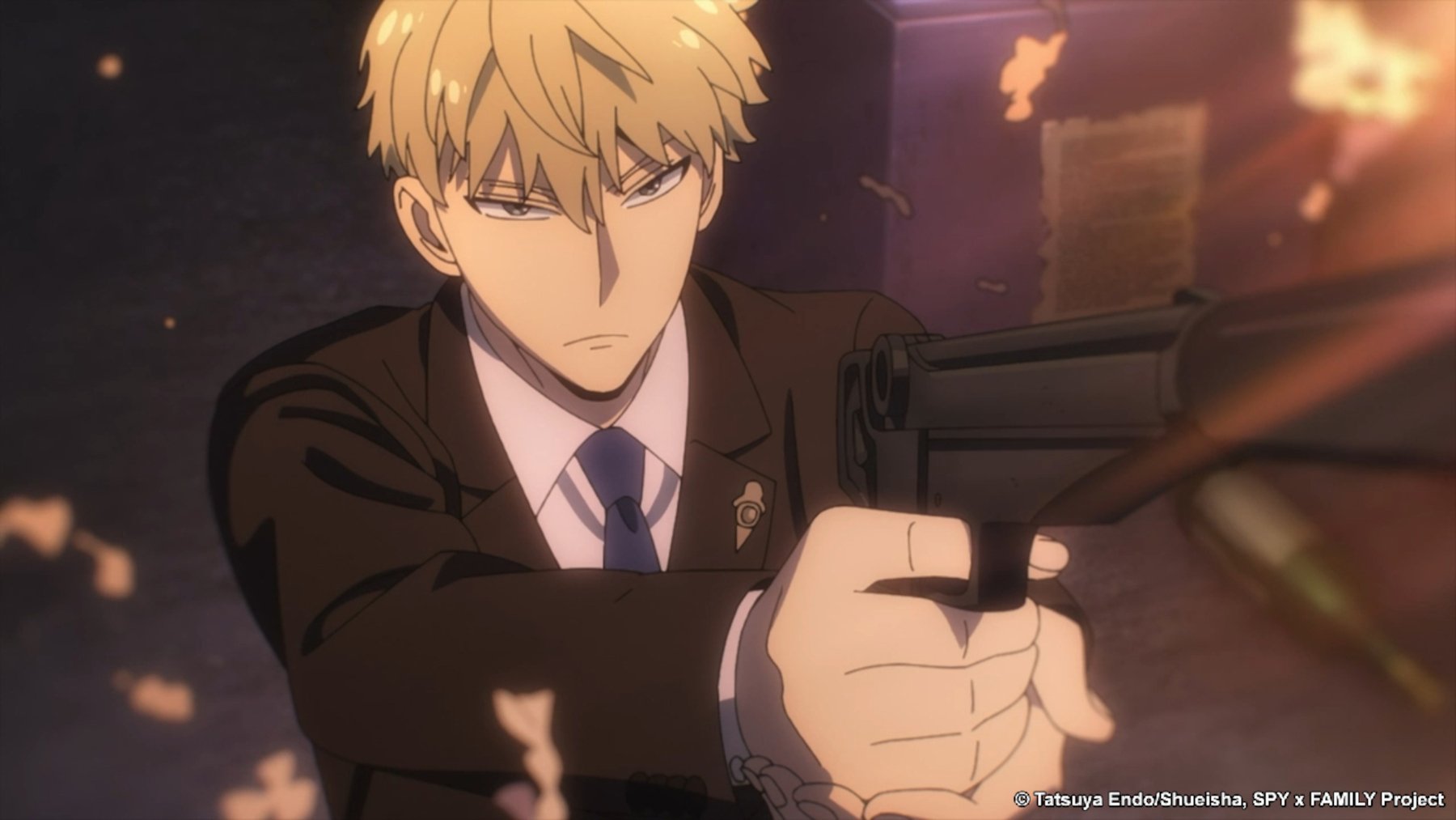 Twilight in 'Spy x Family' Part 2 for our article about what time it comes out on Crunchyroll. He's wearing a suit, holding a gun, and looks angry.